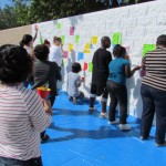 Volunteers help paint the Mural for Equality.