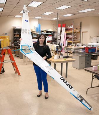 Piñón holds the radio-controlled Prandtl-D flying wing she helped to design and build. (NASA / Tom Tschida) 
