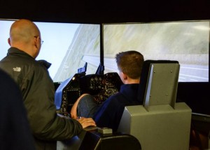 A student experiences the F-16 Simulator at the 412th Electronic Warfare group. (Rebecca Amber) 