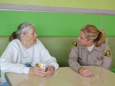Deputy Jodi Wolfe sits for a chat with a resident.
