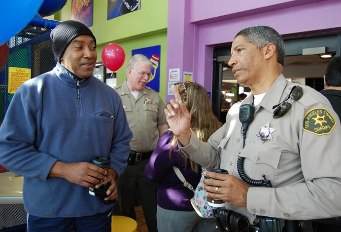 Palmdale Sheriff's Station deputy Ray Wilson speaks with a local business owner at the Palmdale Stations first 'Coffee with a Cop' event Feb. 7.