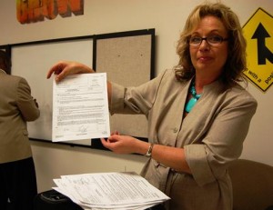 Michelle Egberts holds up one from a stack of petitions for dismissal, which she says were complete through the workshops and granted by the court.