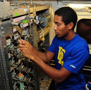 Jonathan Hemingway, an applied meteorology and computational mathematics major at Embry-Riddle Aeronautical University in Florida, assists in installation of the Whole Air Sampler instrument on NASA's DC-8 flying laboratory. (JANE PETERSON)