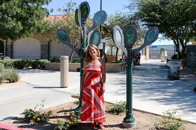 Artist Sol Mesz poses in front of her newly unveiled artwork titled “Back Home” at the Palmdale Transportation Center.