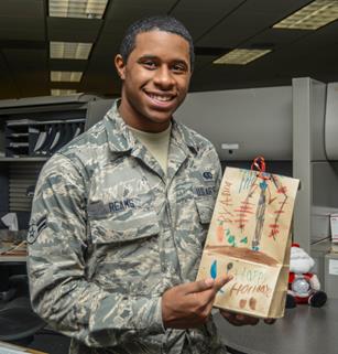 Airman 1st Class Ardell Reams, 412th Force Support Squadron, shows off his bag of holiday cookies. (U.S. Air Force photo by Rebecca Amber) 
