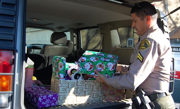 Deputy Miguel Ruiz used the hummer to help distribute presents to local children on Christmas Eve last year. This Saturday, residents are invited to "Stuff the Hummer" with new unwrapped toys for the less fortunate children of Lancaster.