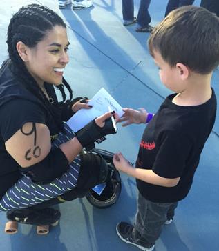 Angelica "Old Ras" Miranda, as a fan runs up to her asking for her signature. "This is what it’s all about. I sweat, bleed and breathe Roller Derby. But without my fans, who is Old Ras?" she stated. (Contributed photo)