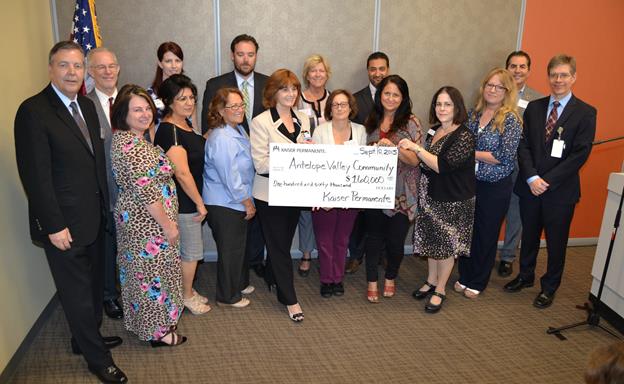 Kaiser Permanente leadership and community partners/recipients at the symbolic check presentation ceremony. Kaiser awarded $139,000 to 10 local community organizations and donated land valued at more than $20,000 to the city of Palmdale. [Contributed image]