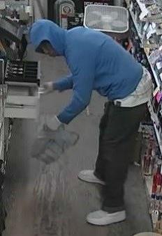 While the victim was on the ground, the suspect removed a large amount of cash from the register. 